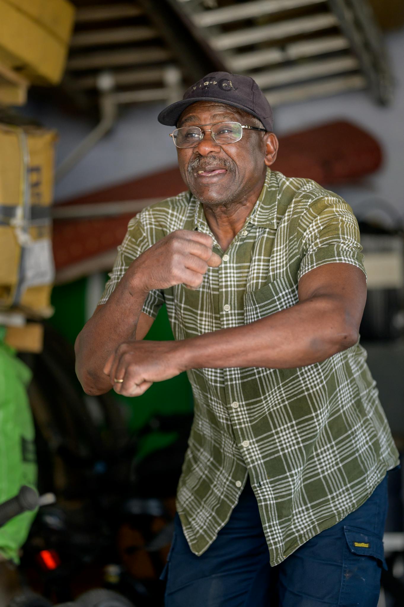 Joyful elderly African American man dancing indoors with a smile.